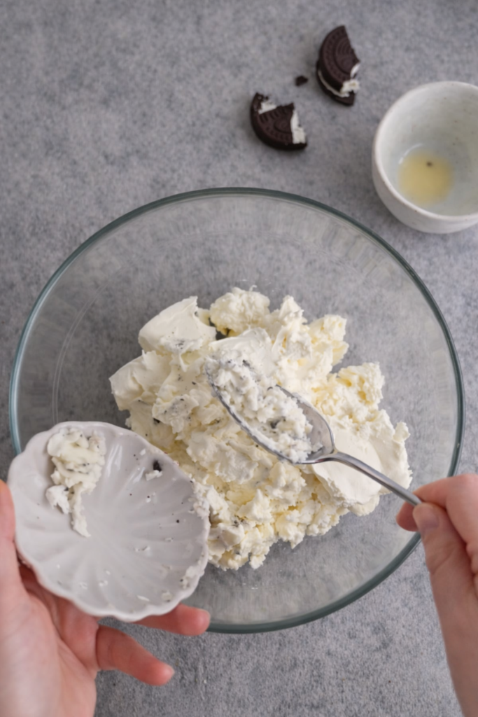 Priprema kreme za čizkejk – krem sir i krema od keksa miješaju se u zdjeli prije pečenja